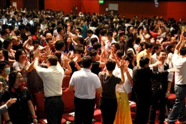 A full room in Hong Kong, every hand in the air